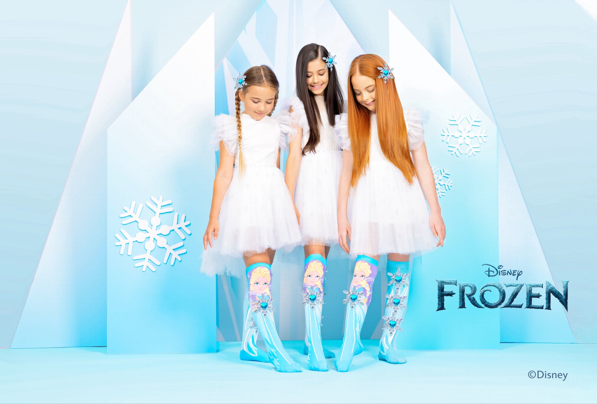 Disney Elsa knee high socks featuring attached sparkly snowflakes and bright Frozen-inspired graphics.